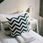 Stylish modern bedroom featuring a chevron pillow and sleek minimalist design.