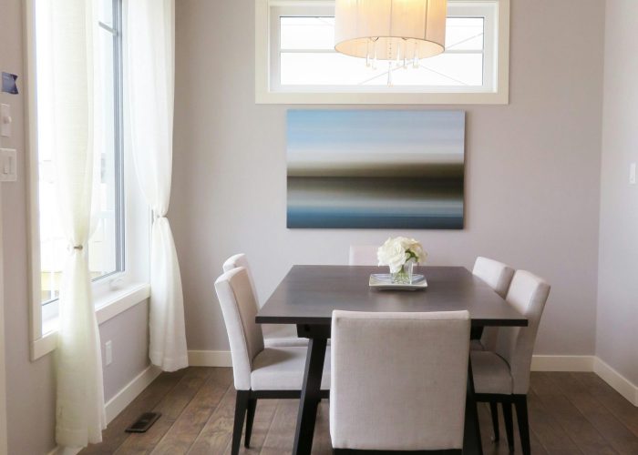 A bright, contemporary dining room with minimalist decor and modern furnishings.